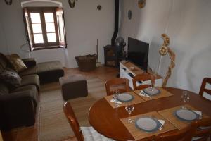 a living room with a wooden table and a couch at Casa do Chico in Mértola