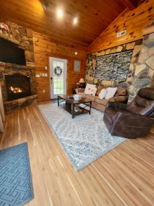 a living room with a couch and a fireplace at High Ridge Cabin with Hot Tub, Starlink Wi-Fi & Whole-House Generator in Stanley