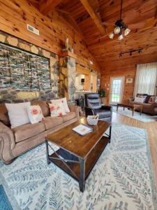 a living room with a couch and a table at High Ridge Cabin with Hot Tub, Starlink Wi-Fi & Whole-House Generator in Stanley
