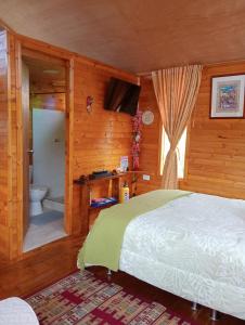 a bedroom with a bed and a bathroom with a toilet at Cabaña Los Linos in Guasca +39 photos