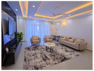 a living room with a couch and a tv at Bahari elegance in Mombasa