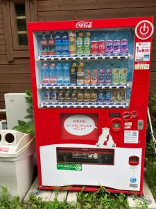 a cocacola soda vending machine with drinks in it at Kitakaruizawa Donguriyama no Ichibanboshi Campsite - Vacation STAY 31715v in Kita-karuizawa