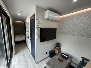 a small room with a tv and a bed at MGBACE - Vacation STAY 19466 in Kubo