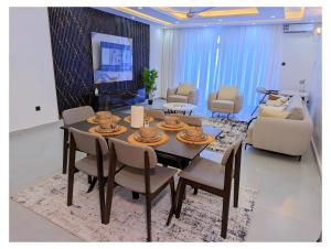 a dining room and living room with a table and chairs at Bahari elegance in Mombasa