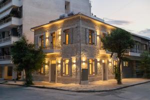 a large stone building with lights on it at Nest in the City Studio Volos in Volos