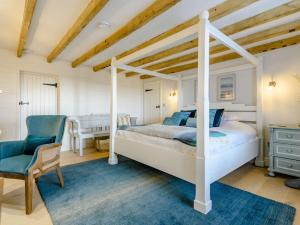 a bedroom with a white bed and a desk at 8 bed in Southerndown 86493 in Southerndown