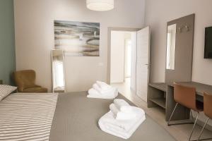 a bedroom with a bed with white towels on it at Casa Chanel in Rome