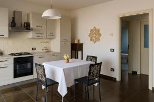 a kitchen with a table and chairs in a kitchen at Trevisan in Cerea