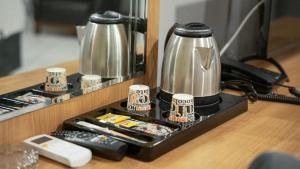 a coffee maker on top of a wooden table at Altınova Hotel Sakarya in Serdivan