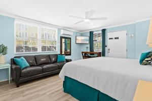 a bedroom with a bed and a couch at Parrot Beach Cottages Suite #1 in Bailey Hall