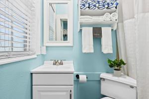 a bathroom with a white sink and a mirror at Parrot Beach Cottages Suite #1 in Bailey Hall +9 photos