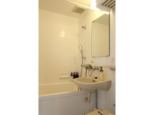 a bathroom with a sink and a bath tub at Smile Hotel Aomori - Vacation STAY 75492v in Aomori +18 photos