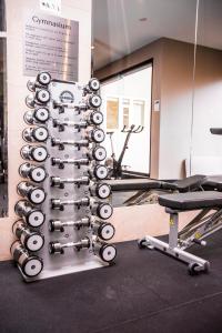 a wall of exercise equipment in a gym at Quay West Suites Melbourne in Melbourne