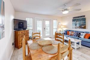 a dining room with a table and a couch at Grand Caribbean West #W113 in Perdido Key