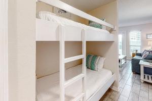 a white bunk bed in a room with a couch at Grand Caribbean West #W113 in Perdido Key +32 photos