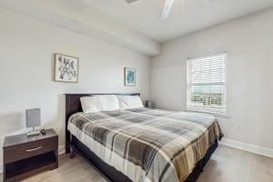 a bedroom with a bed and a nightstand and a window at Seawind 1503 in Gulf Shores +29 photos