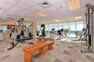 a gym with a bench and treadmills in a building at Seawind 1503 in Gulf Shores