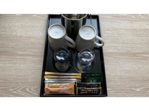 a tray with two coffee mugs and other items at Smile Hotel Premium Hakodate Goryokaku - Vacation STAY 97565v in Hakodate