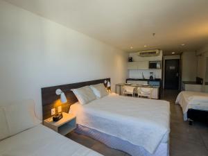 Ένα ή περισσότερα κρεβάτια σε δωμάτιο στο Ritz Suítes 215 Beira-Mar - Hosti