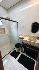 a bathroom with a shower and a toilet and a sink at AMAZON inn JACARÉ in Cruzeiro do Sul +5 photos