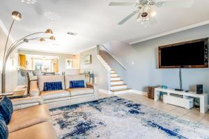 a living room with a couch and a flat screen tv at Sandcastle #18 in Navarre
