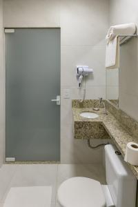 a bathroom with a toilet and a sink at Hotel Solar Bela Vista in Sao Paulo