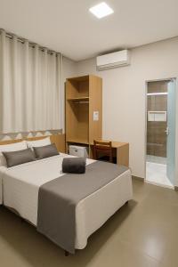 a bedroom with a large bed and a desk at Hotel Solar Bela Vista in Sao Paulo +34 photos