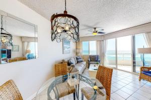 a dining room and living room with a view of the ocean at Silver Beach 704 in Romar Beach
