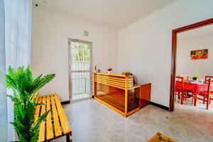 a living room with a wooden bench and a table at Maasai Villa in Arusha