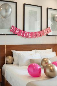 a bed with balloons and a birthday sign on it at The Strabon Tulum in Tulum +26 photos