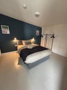 a bedroom with a bed with a blue wall at Corporate Nest Sallins in Balnacart