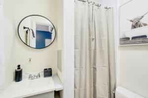 a bathroom with a shower curtain and a mirror at Historic OLD TOWN Block 2 KING ST 99 Walkscore in Alexandria