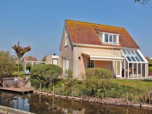 a house with a river in front of it at Holiday Home Breskens near the Coast in Breskens