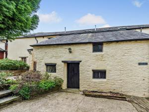 an old white brick house with a black door at 5 Bed in Ilfracombe BARLC in West Down