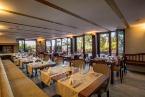 a restaurant with tables and chairs and windows at Bed and Breakfast Saint Alliance in Crikvenica
