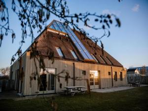 a building with a picnic table in front of it at Apartment with Garden in Dutch Countryside in Callantsoog