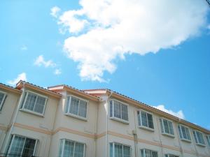 a building with white windows and a blue sky at Hotel Pacific - Vacation STAY 29745v in Ishinomaki