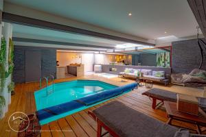 a large swimming pool in a living room at Apartment & Spa L'Oasis Urbaine in Chambéry