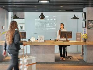 two women standing at a desk in an office at ibis Paris Porte D'Orleans in Montrouge