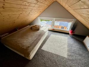 a bedroom with a large bed in a room at Chatka u Mańka in Świeradów-Zdrój