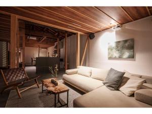 a living room with a couch and a table at Keyakizaka - Vacation STAY 12550v in Ogi
