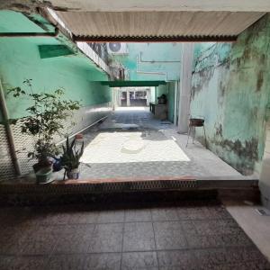 an empty hallway in an old building with plants at Casa cop30 in Belém