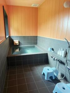 a bathroom with a bath tub and a sink at Hot Spring Guest House Mikunien - Vacation STAY 18629v in Sakai +11 photos