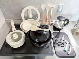 a kitchen counter with a sink with a pot and utensils at Minamiaso Sauna 5GAKU - Vacation STAY 24181v in Minami Aso