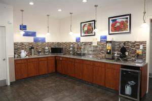 a large kitchen with a counter top in a room at Americas Best Value Inn Monroe in Monroe