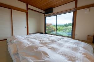 a large bed in a room with a large window at Fujinomiya - House - Vacation STAY 20037 in Fujinomiya