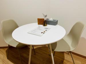 a white table with three chairs and a box on it at Onomichi Stay Gen - Vacation STAY 24149v in Onomichi +14 photos