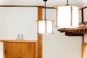 a room with three pendant lights on a wall at Onomichi Stay Gen - Vacation STAY 24149v in Onomichi