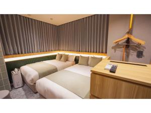 a hotel room with two beds and a desk at THE GALA HOTEL UMEDA - Vacation STAY 24224v in Osaka