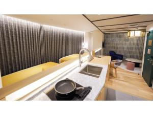 a kitchen with a frying pan on a stove at THE GALA HOTEL UMEDA - Vacation STAY 24233v in Osaka +16 photos